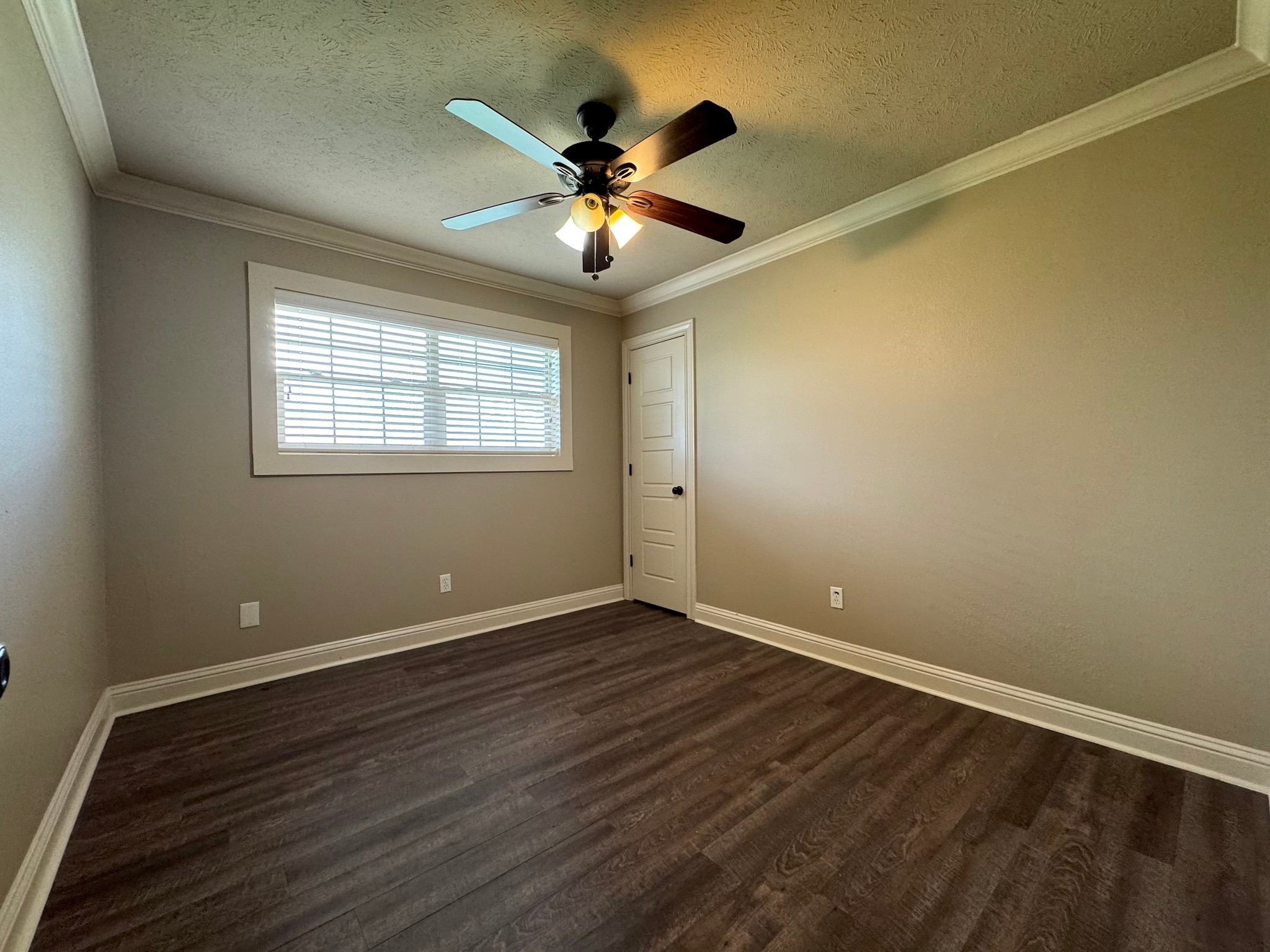 114 Elmwood Street Huntsville, TX 77320 - Photo 13 of 18 a view of an empty room with wooden floor and a window