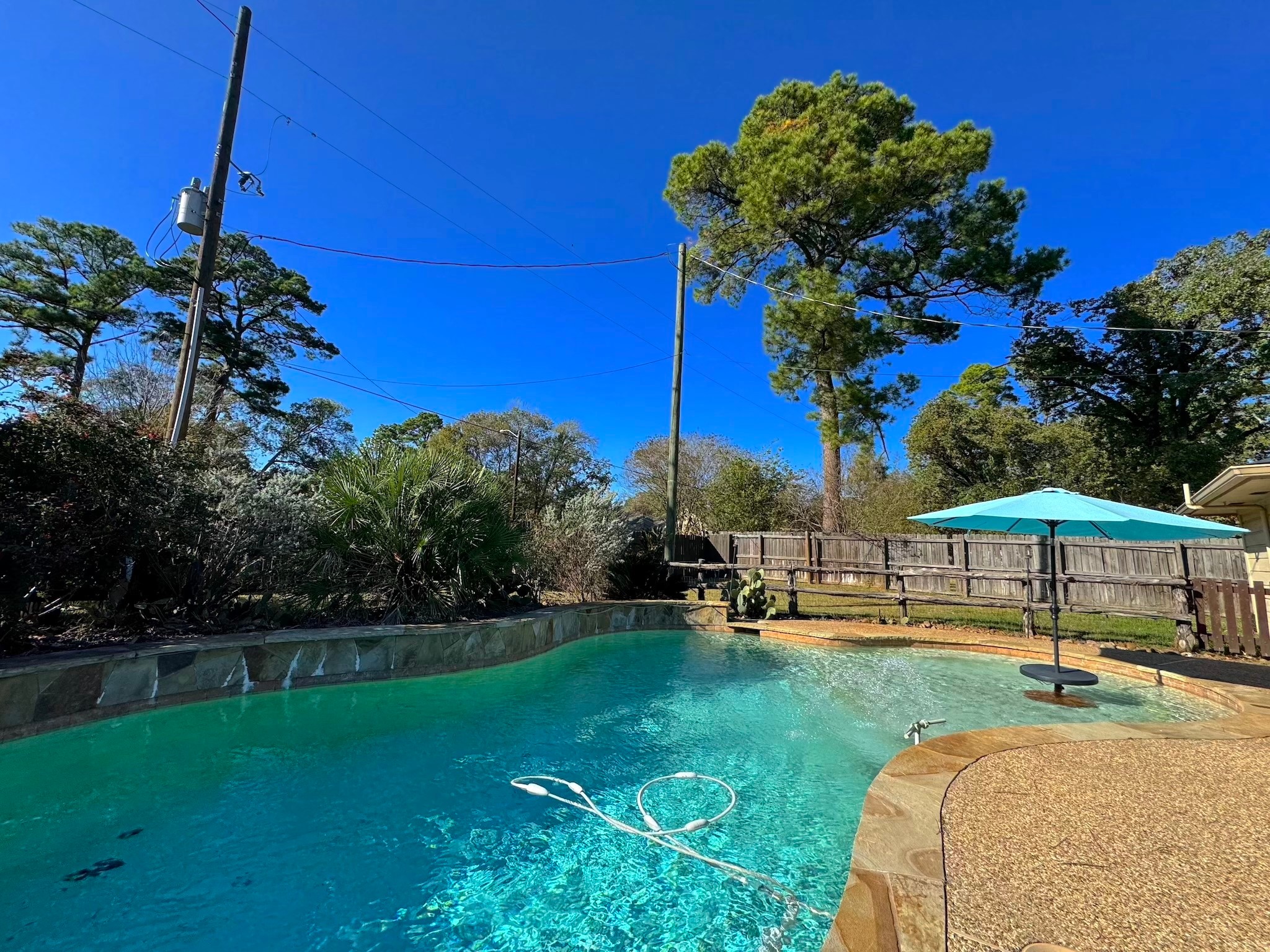 114 Elmwood Street Huntsville, TX 77320 - Photo 18 of 18 a view of a house with a backyard and a patio