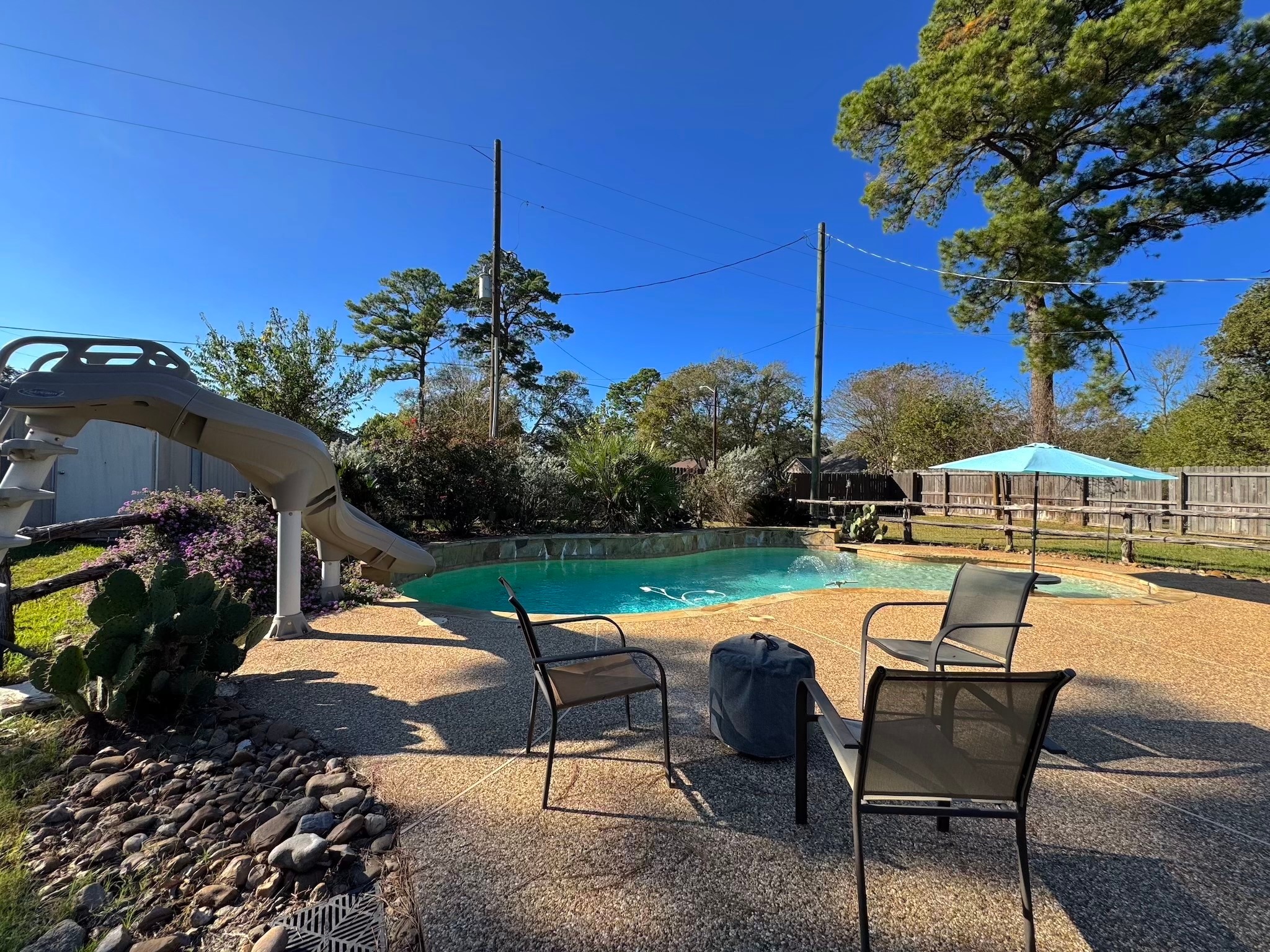 114 Elmwood Street Huntsville, TX 77320 - Photo 2 of 18 a view of a swimming pool with a lounge chairs