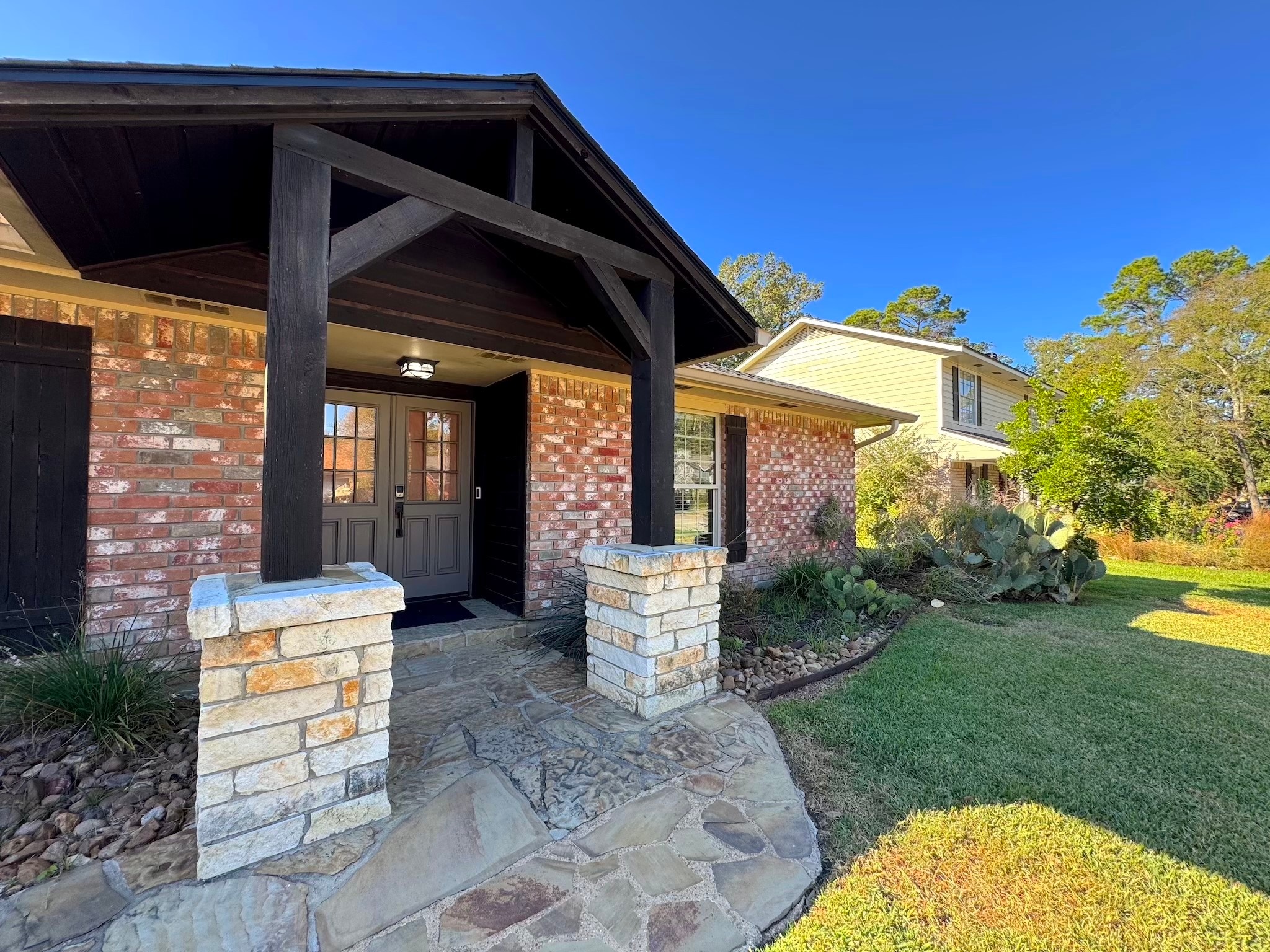 114 Elmwood Street Huntsville, TX 77320 - Photo 4 of 18 a front view of a house with garden