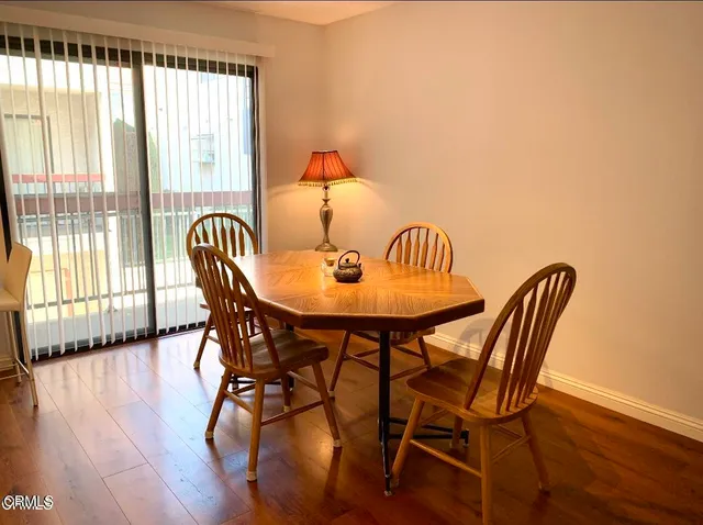 a dining room with furniture and wooden floor
