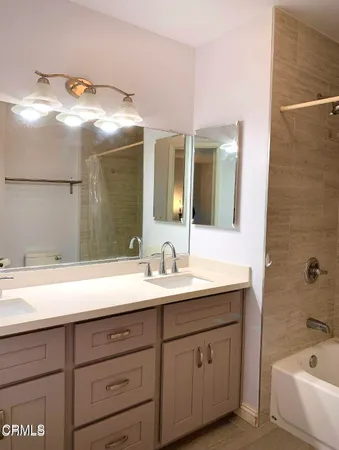 a bath room with a sink and a mirror