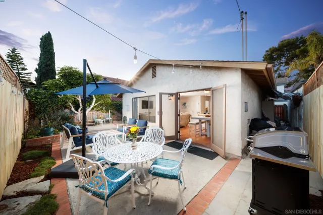a view of a patio with table and chairs potted plants with wooden floor