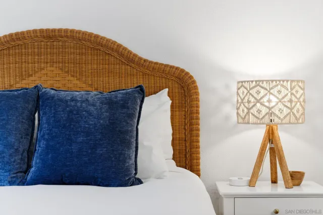 a bed sitting in a bedroom and chair