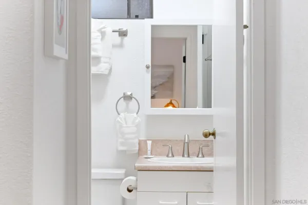 a bathroom with a sink vanity and mirror