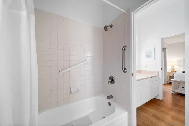 a bathroom with a bathtub a toilet and a shower