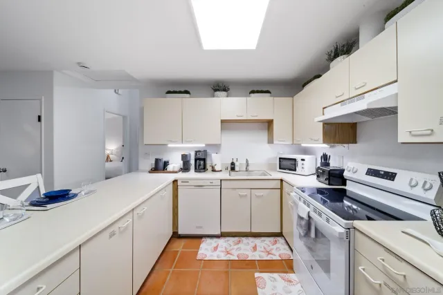 a kitchen with a sink cabinets and appliances