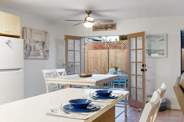 a dining room with furniture and a chandelier