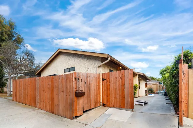 a view of a house with wooden fence and floor