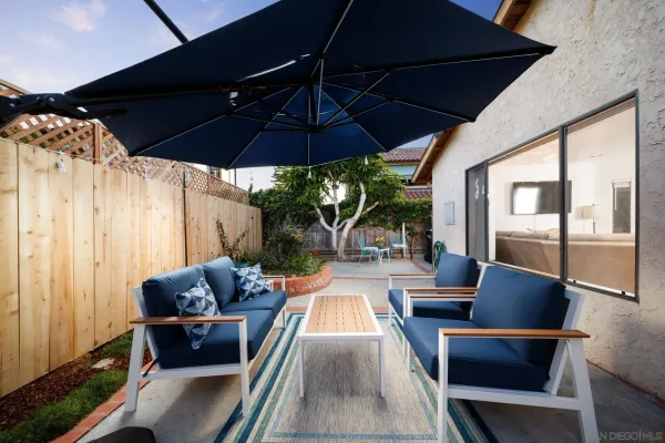 a outdoor sitting area with furniture and umbrella