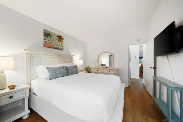 a bedroom with a bed and a flat screen tv