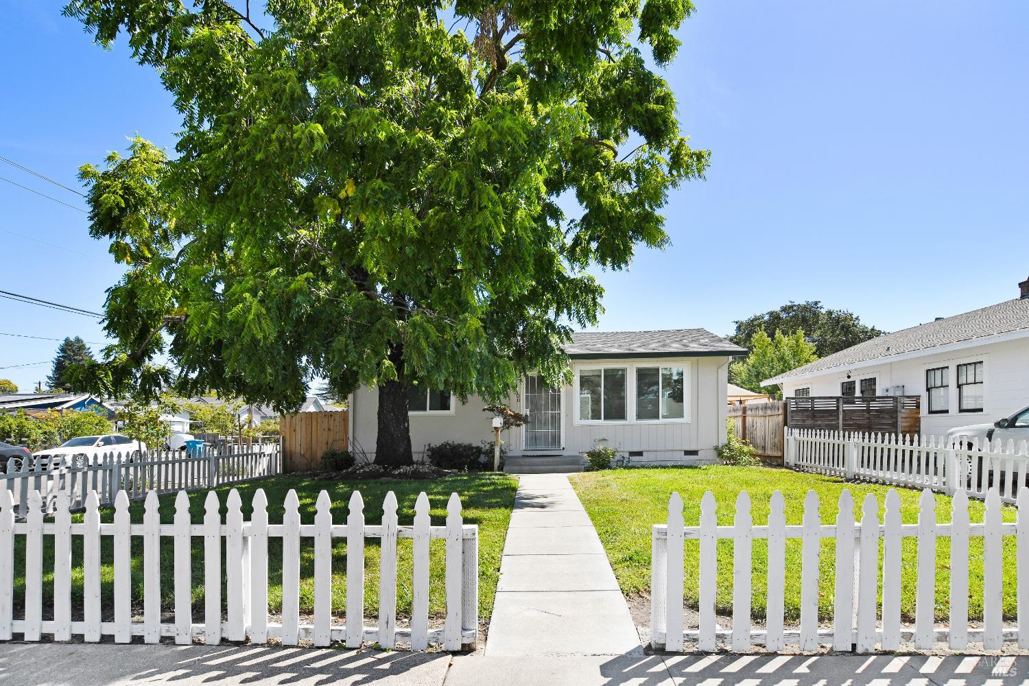a view of a house with a wooden deck