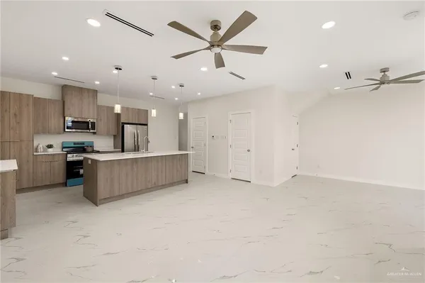 a view of kitchen with furniture and stainless steel appliances