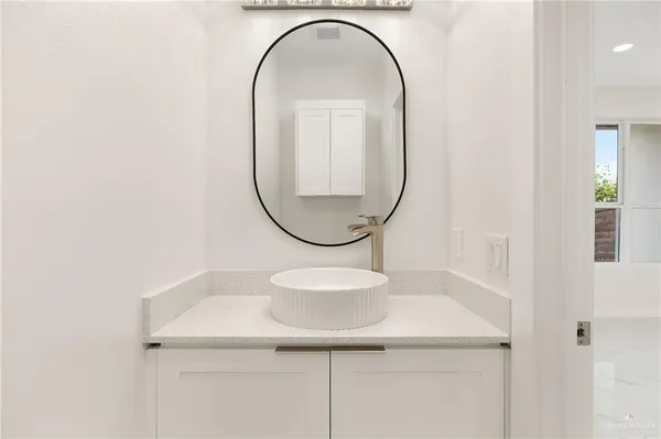 a bathroom with a sink and a mirror