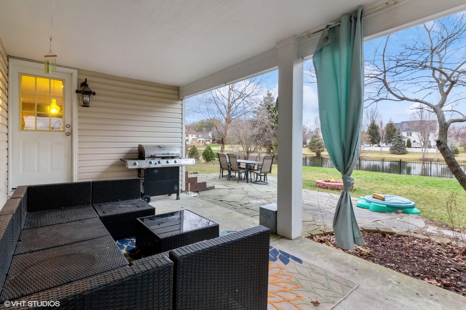 1004 Vineyard Lane Aurora, IL 60502 - Photo 19 of 24 a view of a patio with table and chairs potted plants with wooden floor