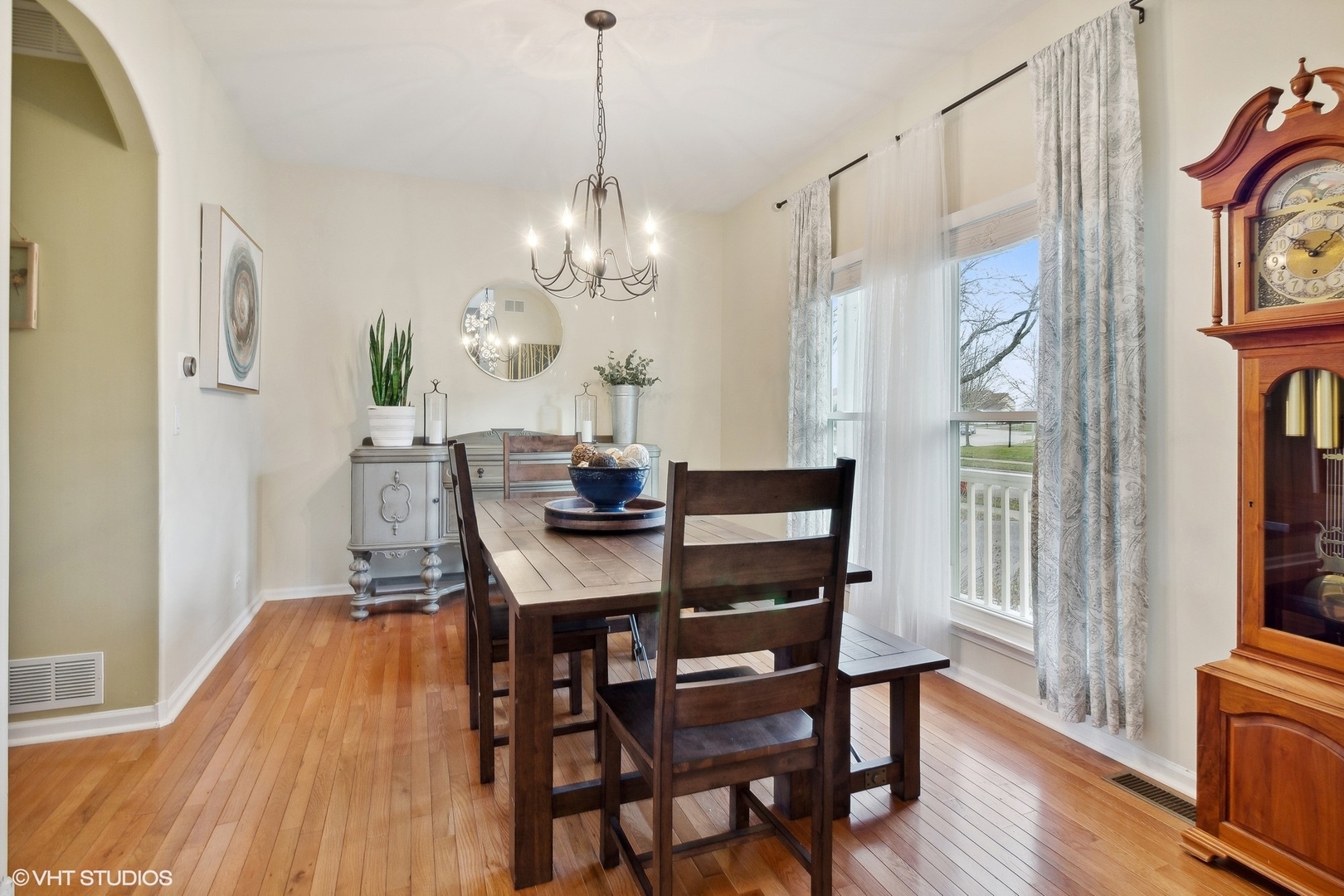1004 Vineyard Lane Aurora, IL 60502 - Photo 2 of 24 a view of a dining room with furniture a chandelier and wooden floor