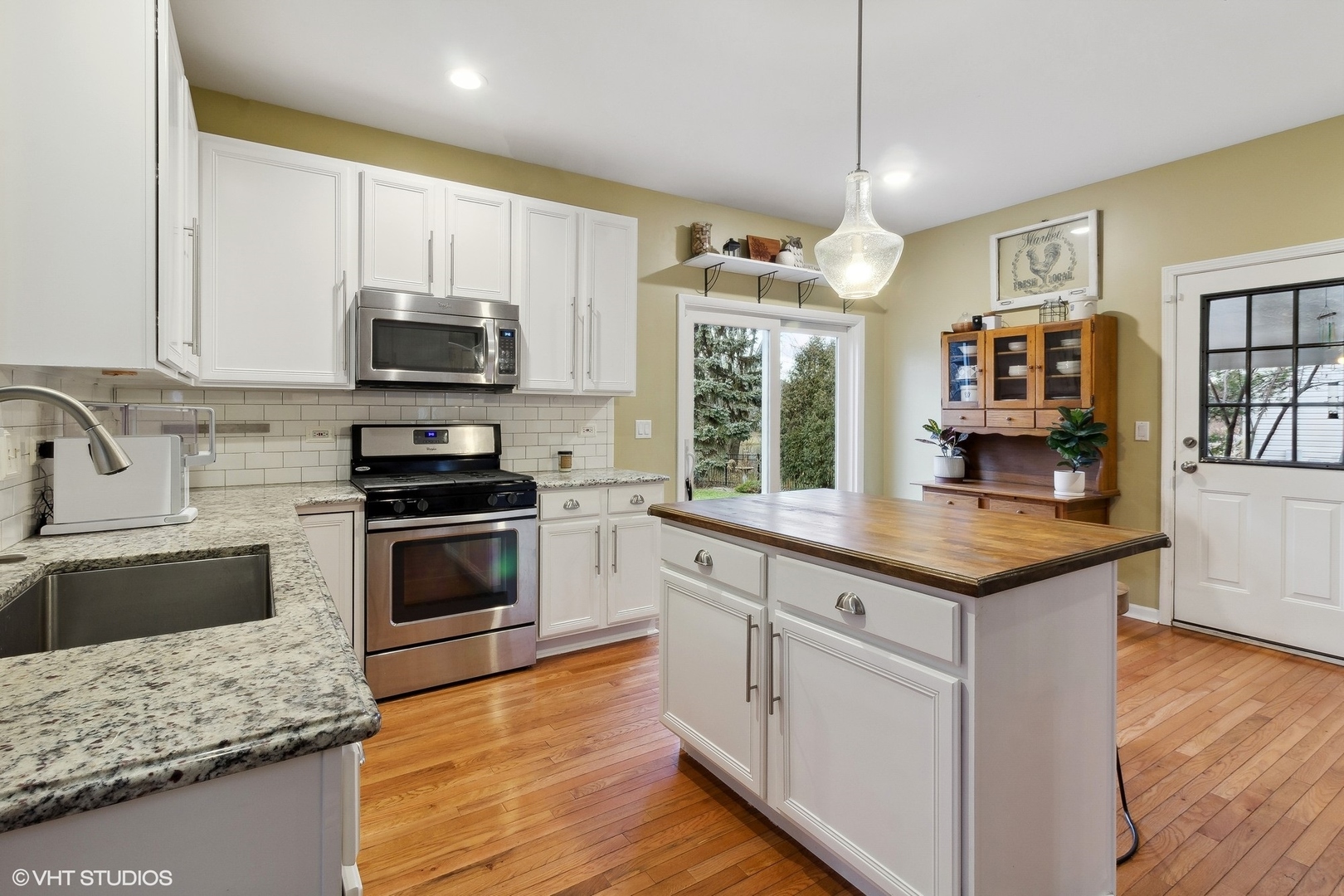 1004 Vineyard Lane Aurora, IL 60502 - Photo 6 of 24 a kitchen with stainless steel appliances granite countertop a stove top oven a sink dishwasher and a microwave oven with cabinets