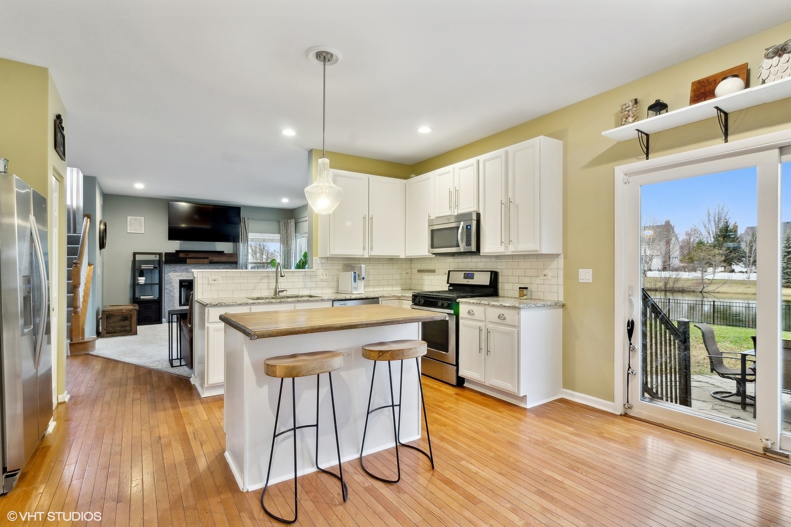 1004 Vineyard Lane Aurora, IL 60502 - Photo 7 of 24 a kitchen with stainless steel appliances granite countertop a refrigerator a stove top oven a sink dishwasher and white cabinets with wooden floor
