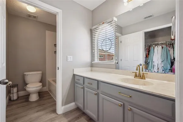 a bathroom with a sink toilet a mirror and vanity