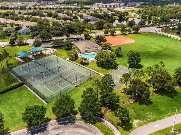 an aerial view of residential houses with outdoor space and swimming pool