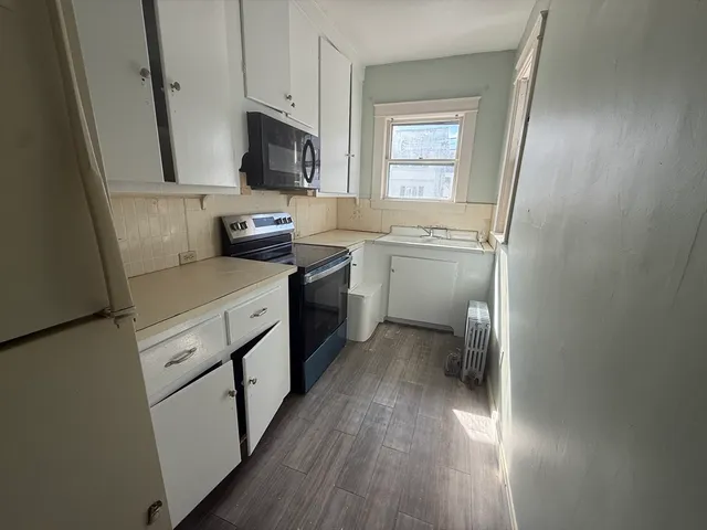 a kitchen with a sink stove and refrigerator
