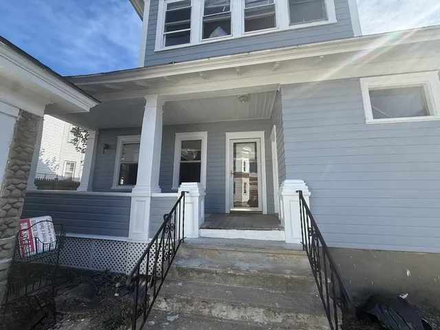 a view of a house with a wooden fence