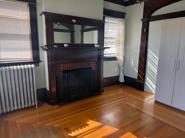 a bedroom with a bed and a fireplace