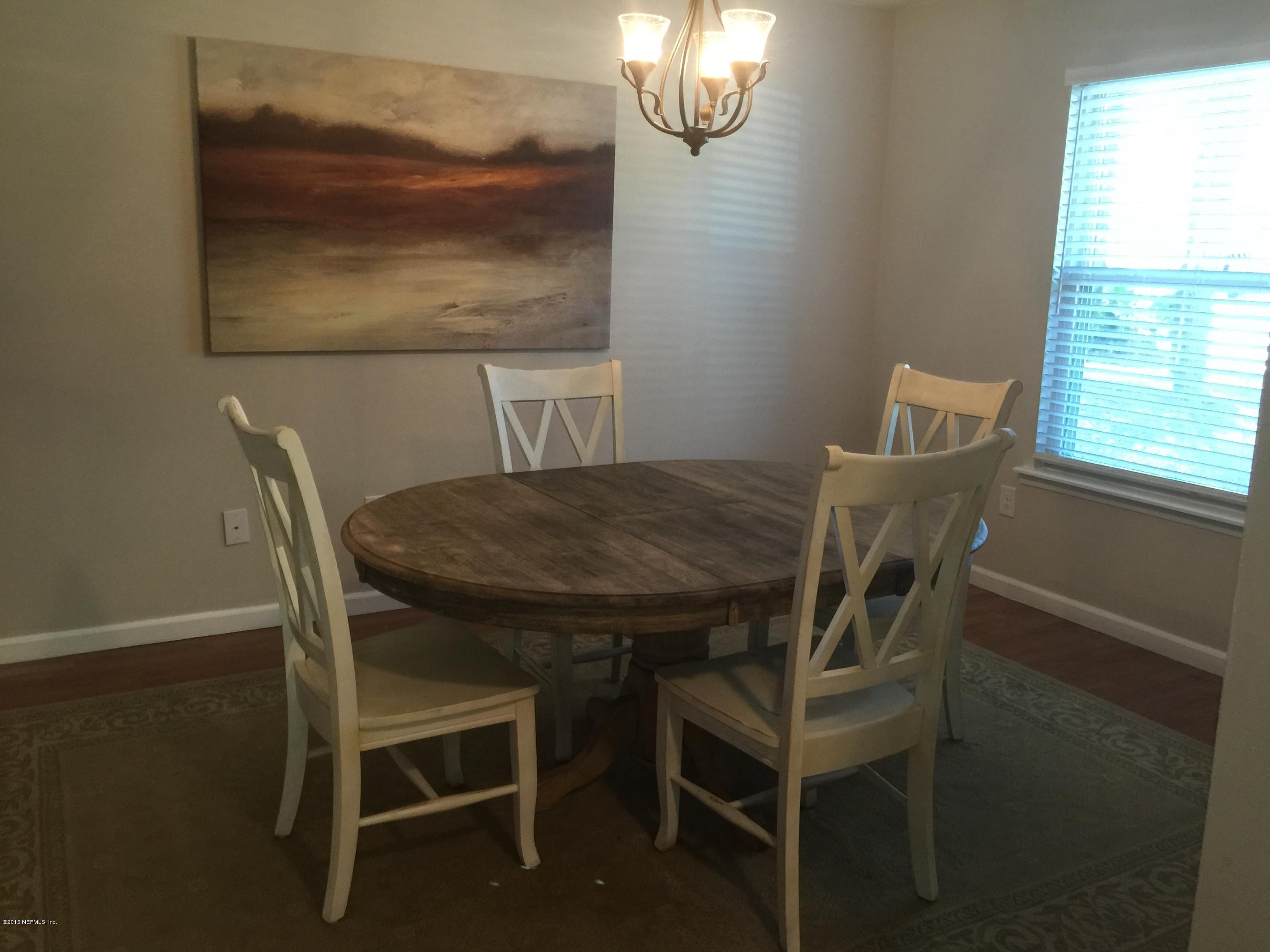 11019 Reading Road Jacksonville, FL 32257 - Photo 4 of 28 a view of a dining room with furniture and chandelier