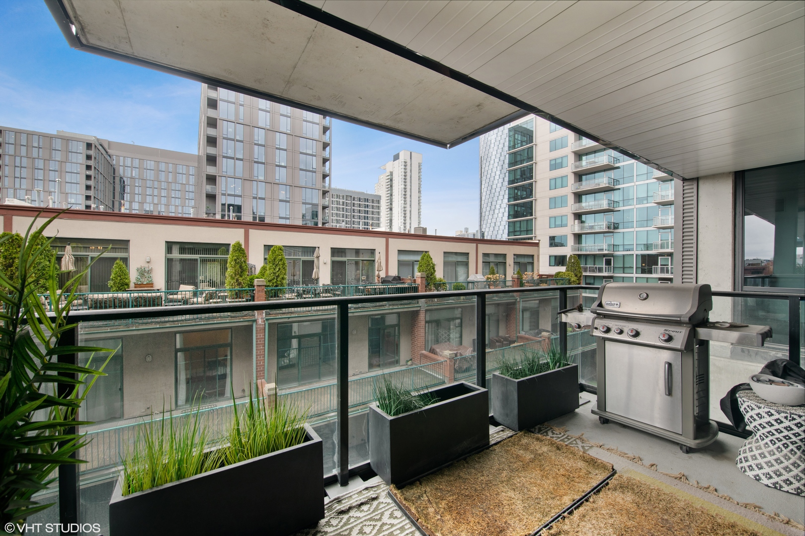 111 South Peoria Street, Unit 503 Chicago, IL 60607 - Photo 28 of 29 a view of roof deck with dining table and chairs