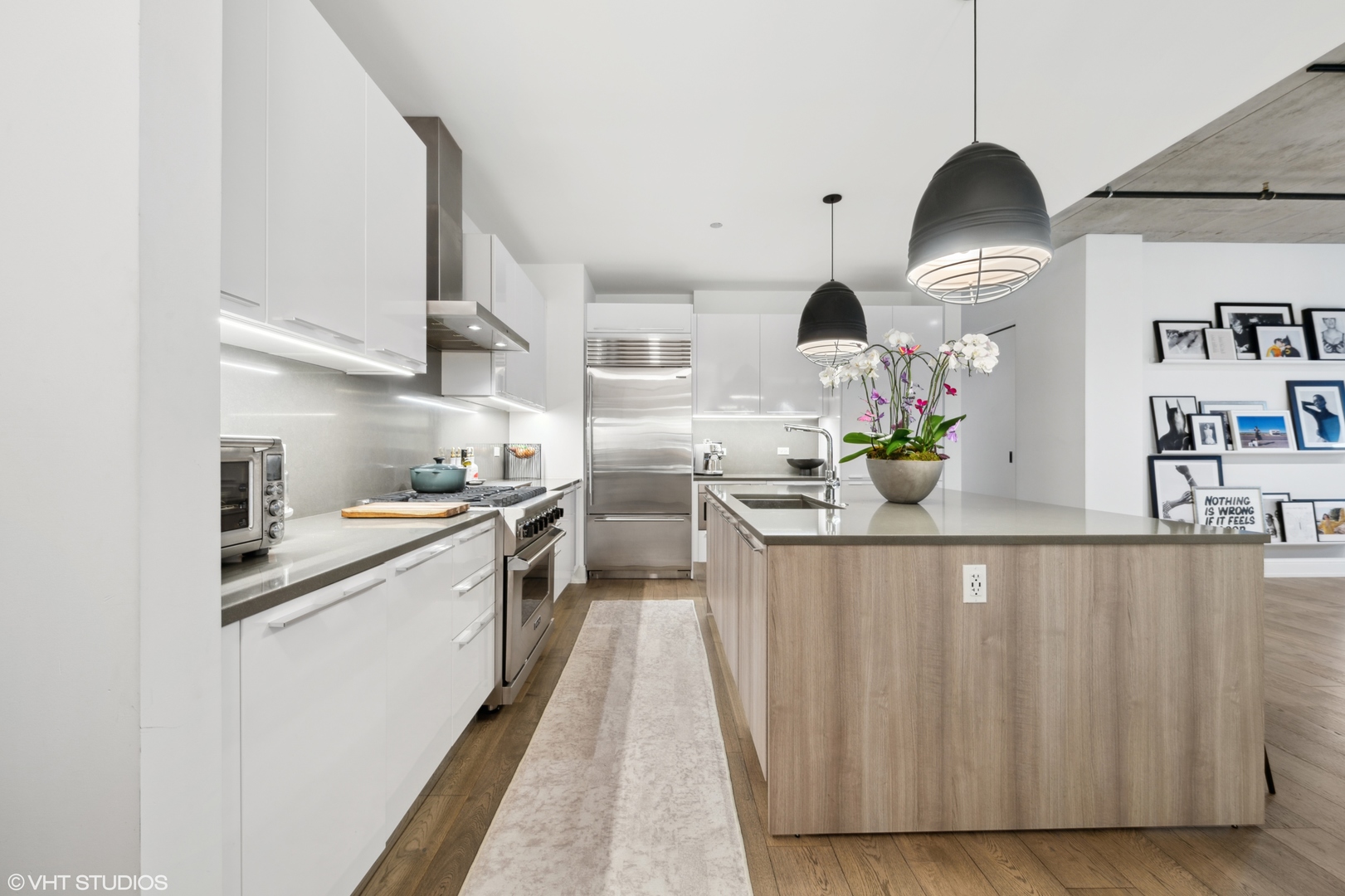 111 South Peoria Street, Unit 503 Chicago, IL 60607 - Photo 6 of 29 a kitchen with stainless steel appliances granite countertop a sink a stove and a wooden floors