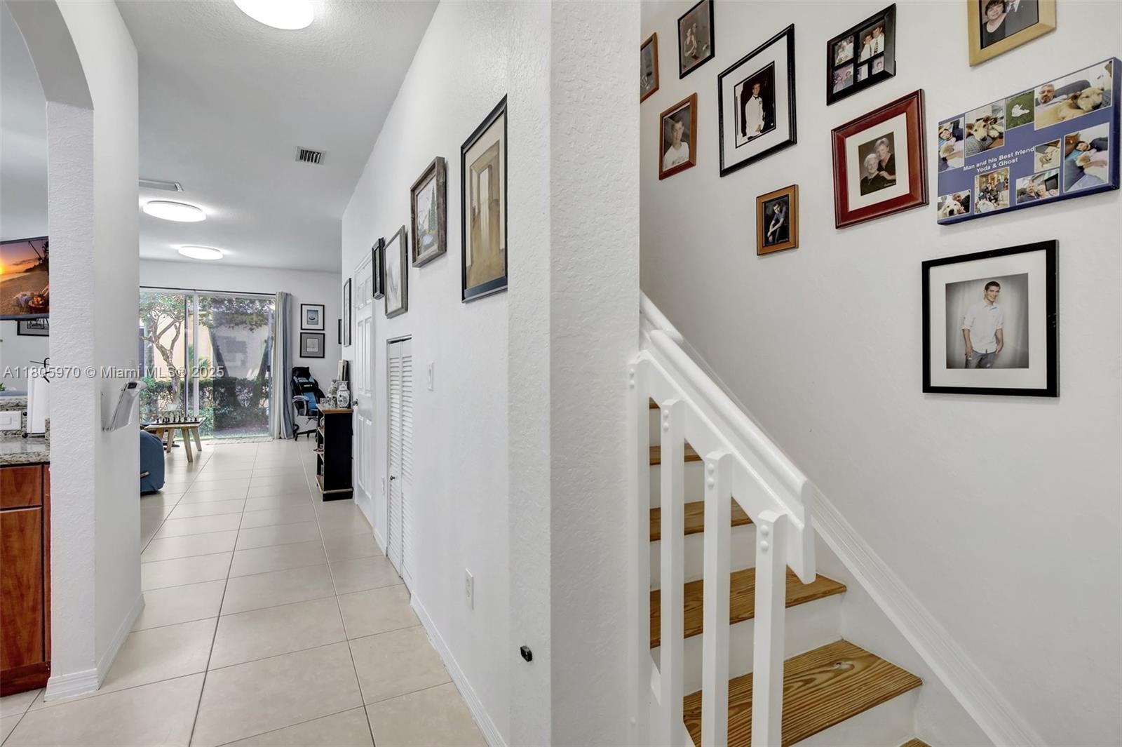 8999 Southwest 18th Street, Unit 1401 Miramar, FL 33025 - Photo 12 of 51 a view of a hallway with paintings on the wall