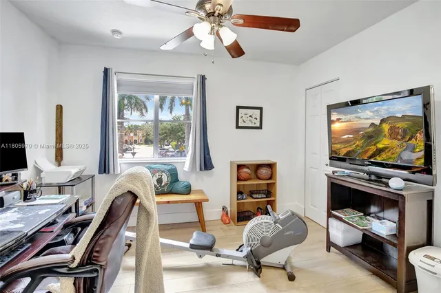 a living room with furniture a window and a flat screen tv