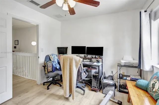a view of a livingroom with workspace and a window