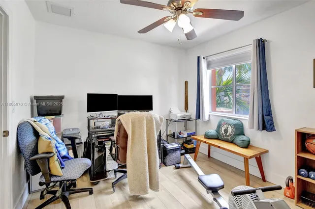 a living room with furniture a flat screen tv and a window