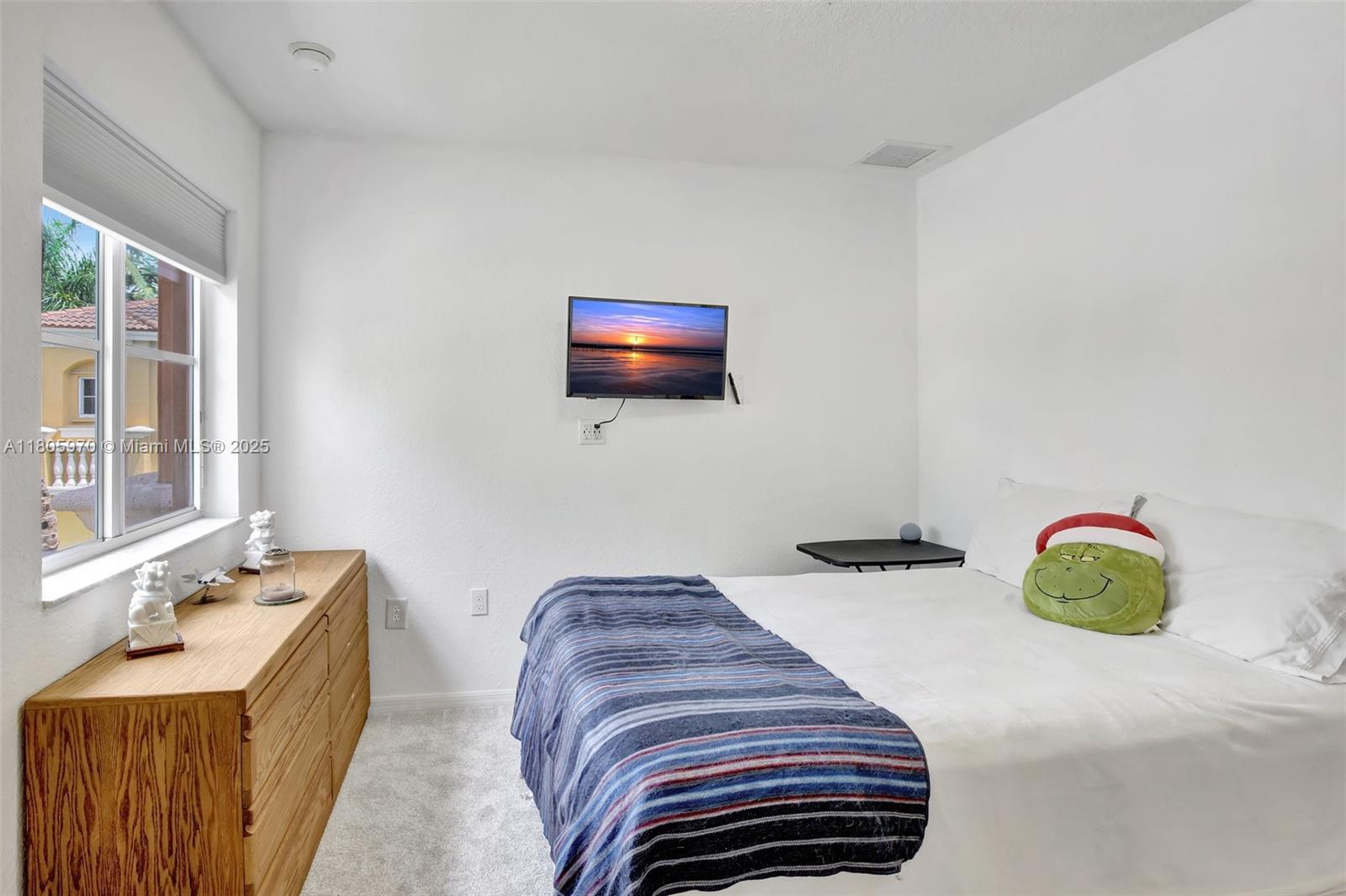 8999 Southwest 18th Street, Unit 1401 Miramar, FL 33025 - Photo 19 of 51 a bedroom with a bed and a chair