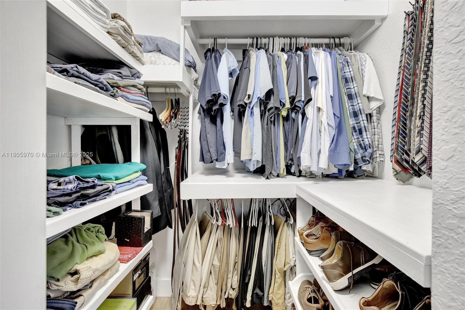8999 Southwest 18th Street, Unit 1401 Miramar, FL 33025 - Photo 25 of 51 a view of walk in closet with clothes and shoes