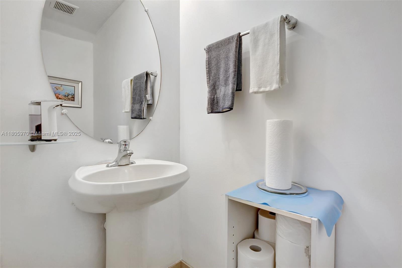 8999 Southwest 18th Street, Unit 1401 Miramar, FL 33025 - Photo 28 of 51 a bathroom with a sink and a mirror