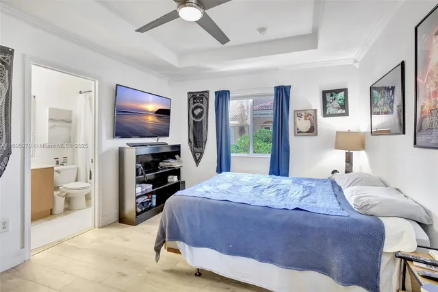 a living room with furniture a flat screen tv and a large window