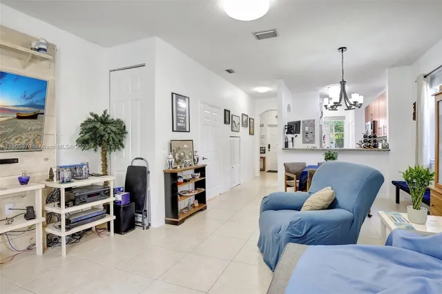 a view of a dining room with furniture and a chandelier