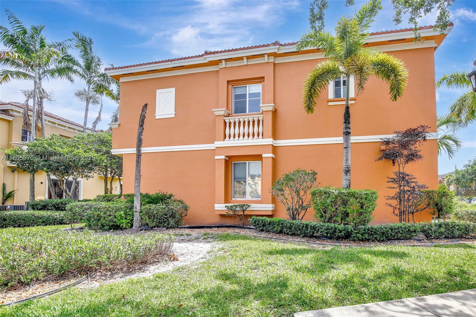 8999 Southwest 18th Street, Unit 1401 Miramar, FL 33025 - Photo 4 of 51 a front view of a house with a yard