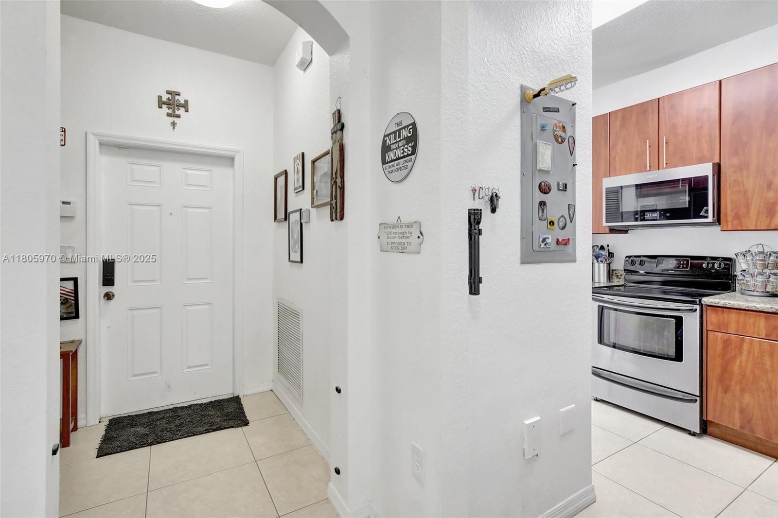 8999 Southwest 18th Street, Unit 1401 Miramar, FL 33025 - Photo 43 of 51 a kitchen with a refrigerator and microwave