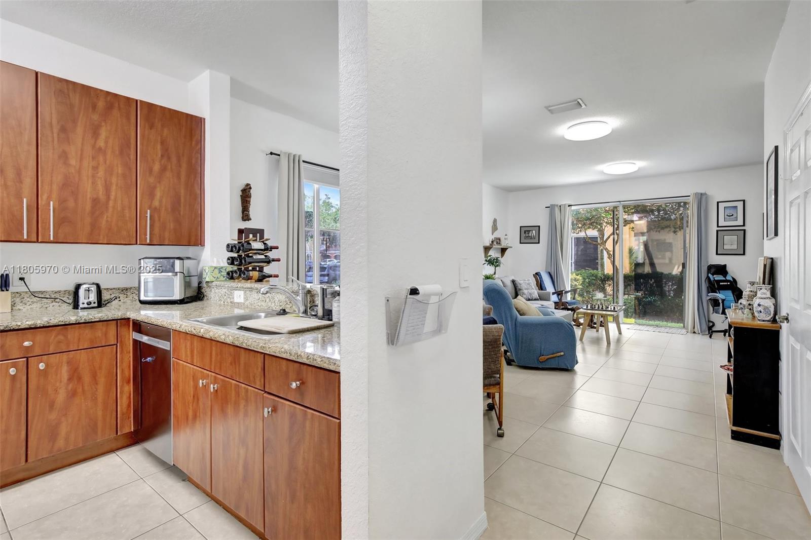 8999 Southwest 18th Street, Unit 1401 Miramar, FL 33025 - Photo 45 of 51 a kitchen with a sink and cabinets