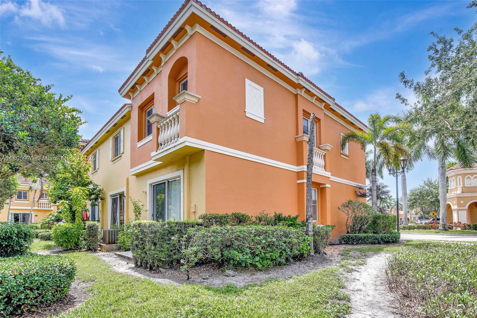 8999 Southwest 18th Street, Unit 1401 Miramar, FL 33025 - Photo 6 of 51 a front view of a house with a yard