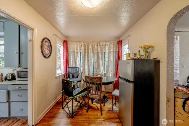 a view of dining room with wooden floor and furniture