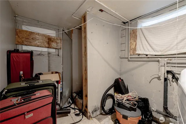 a room with gym equipment and wooden floor