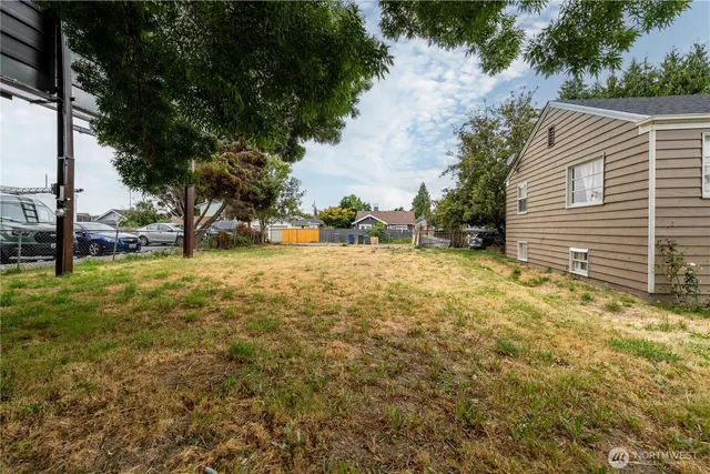 a view of a house with a patio and a yard
