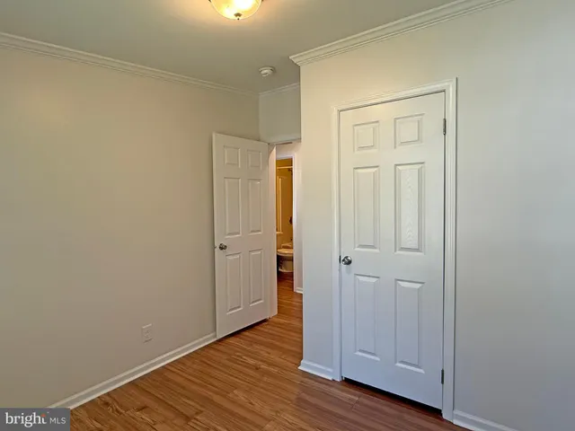 a view of an empty room and wooden floor