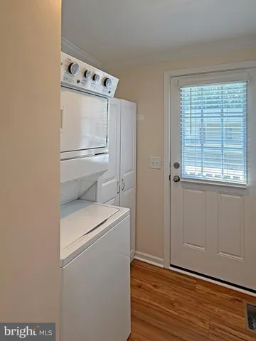 a view of a hallway with wooden floor and closet