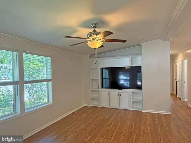 a living room with a fireplace and a flat screen tv