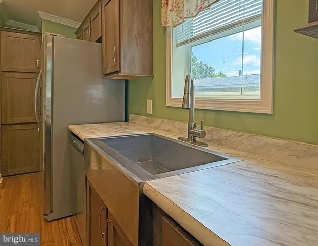 a kitchen with a refrigerator and a sink